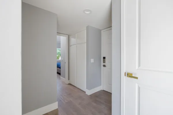 a view of hallway with wooden floor