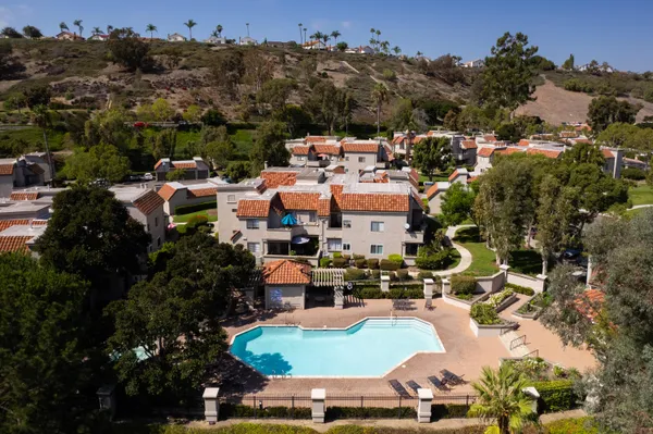 an aerial view of residential houses with outdoor space