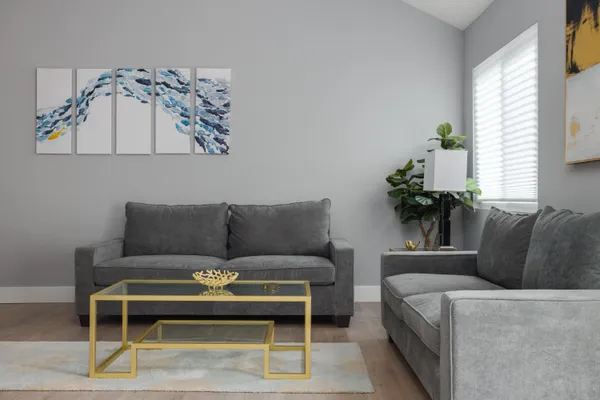 a living room with furniture rug and window