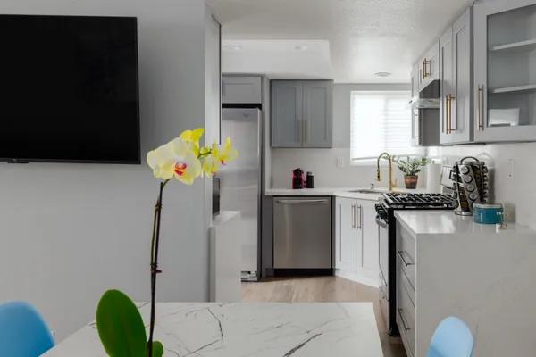 a kitchen with a sink appliances and cabinets