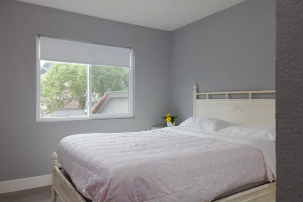a bedroom with a bed and window