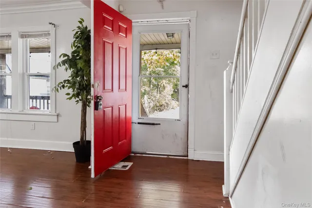 a view of an entryway with wooden floor