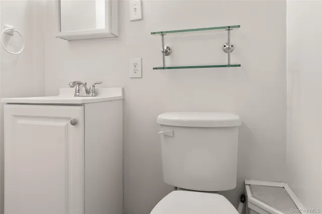 a white toilet sitting next to a bathroom sink