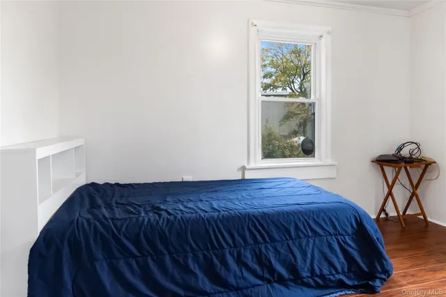 a bed sitting in a bedroom next to a window