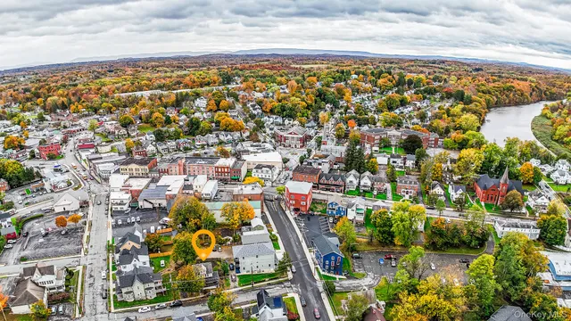an aerial view of residential building and yard