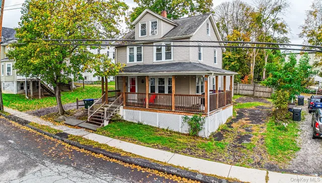a view of a house with a yard and sitting area
