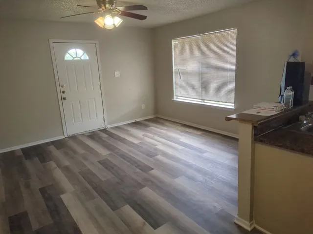 wooden floor in an empty room with a window