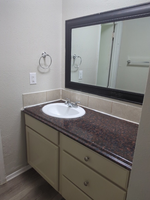512 Lenora Drive, Unit B Taylor, TX 76574 - Photo 8 of 11 a bathroom with a sink and a mirror