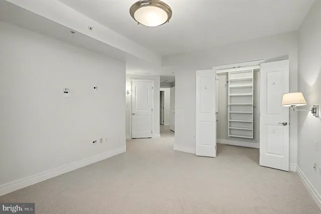 a view of walk in closet with empty racks