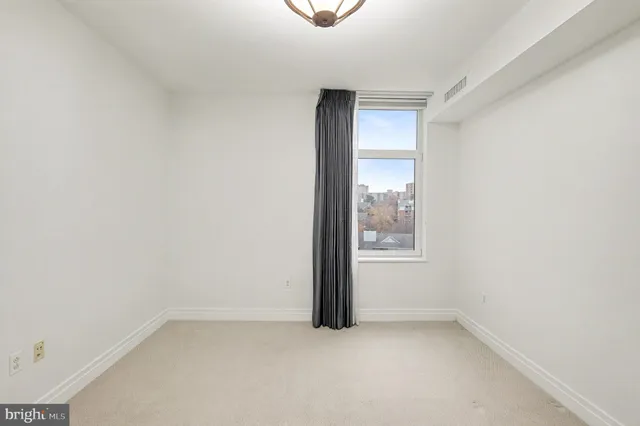 a view of a room with wooden floor and glass door