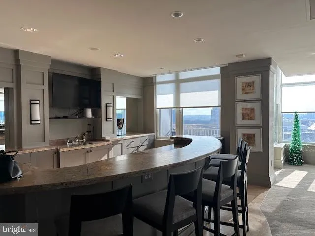 a room with pool table and windows