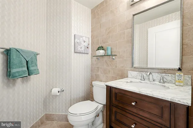 a bathroom with a sink toilet and mirror