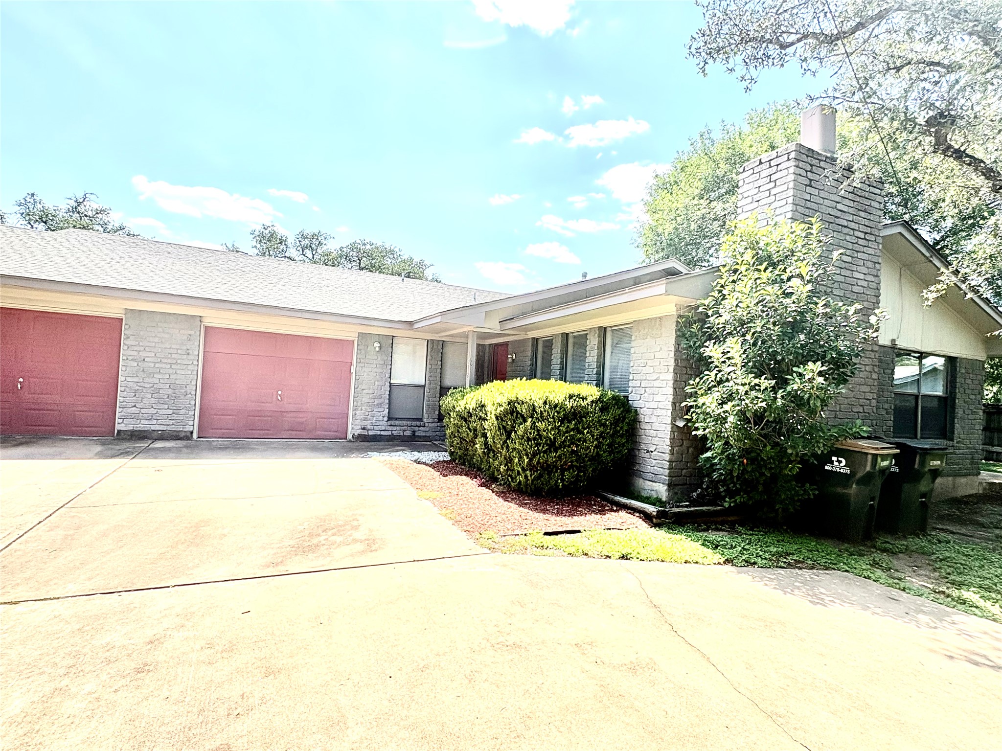 1212 Leander Road, Unit A Georgetown, TX 78628 - Photo 3 of 20 A classic brick exterior offers generous garage space and a neatly landscaped front.