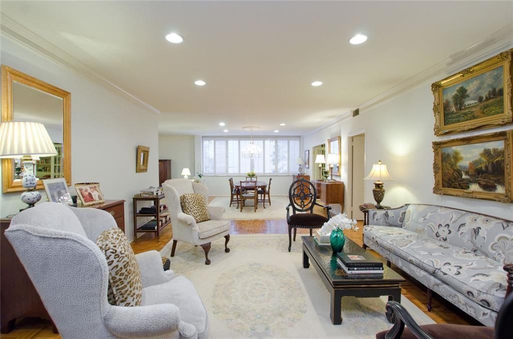 a living room with furniture and a lamp