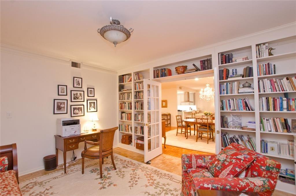 2734 Peachtree Road Northwest, Unit C101 Atlanta, GA 30305 - Photo 11 of 23 a living room with furniture and a book shelf