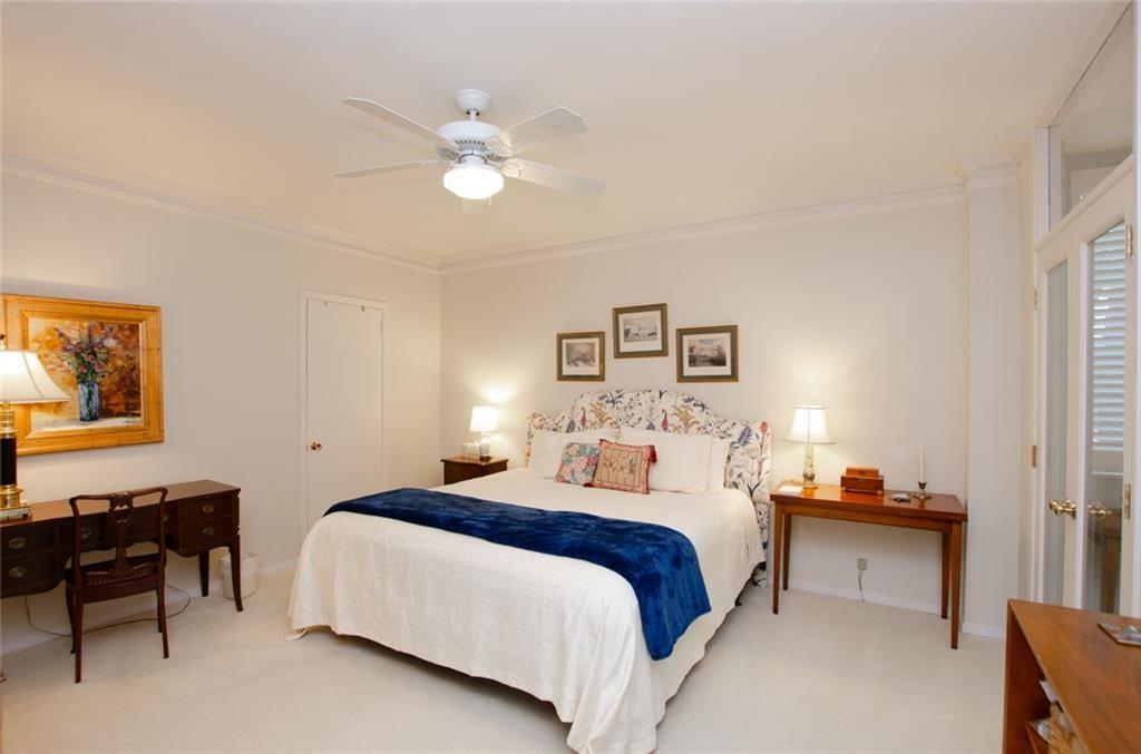 2734 Peachtree Road Northwest, Unit C101 Atlanta, GA 30305 - Photo 12 of 23 a bedroom with a bed and a chandelier