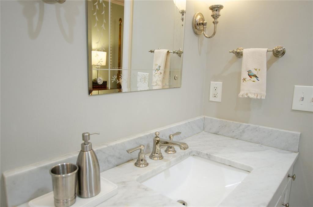 2734 Peachtree Road Northwest, Unit C101 Atlanta, GA 30305 - Photo 13 of 23 a bathroom with a sink and a mirror