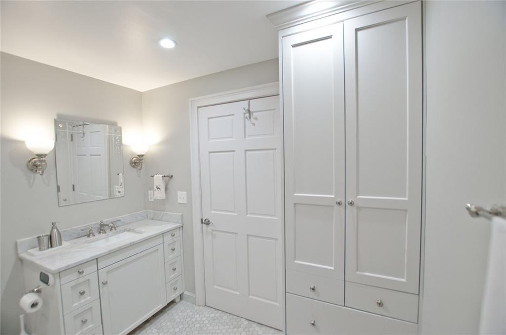 2734 Peachtree Road Northwest, Unit C101 Atlanta, GA 30305 - Photo 17 of 23 a bathroom with a sink and a mirror