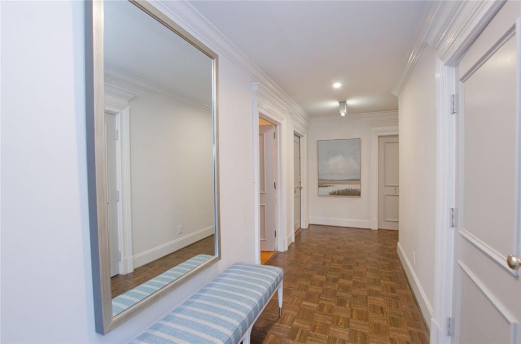 2734 Peachtree Road Northwest, Unit C101 Atlanta, GA 30305 - Photo 19 of 23 a view of a hallway with wooden floor and a bathroom