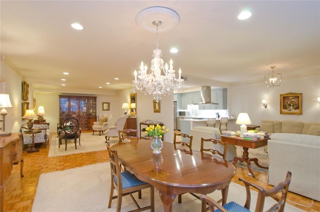 2734 Peachtree Road Northwest, Unit C101 Atlanta, GA 30305 - Photo 2 of 23 a view of a dining room with furniture and chandelier