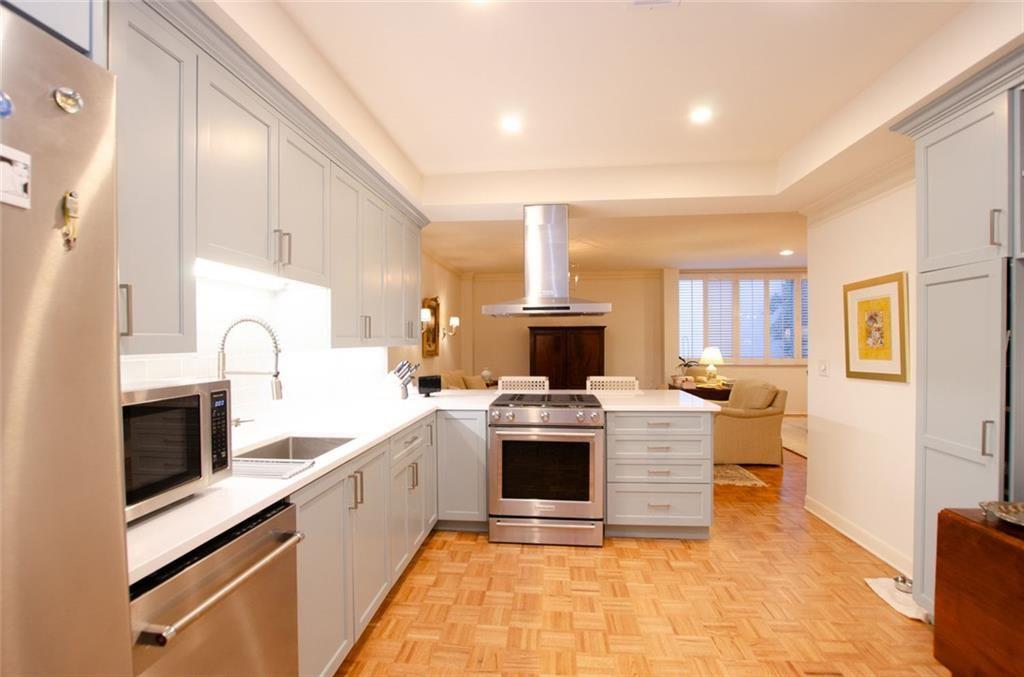 2734 Peachtree Road Northwest, Unit C101 Atlanta, GA 30305 - Photo 5 of 23 a kitchen with a sink a stove and cabinets