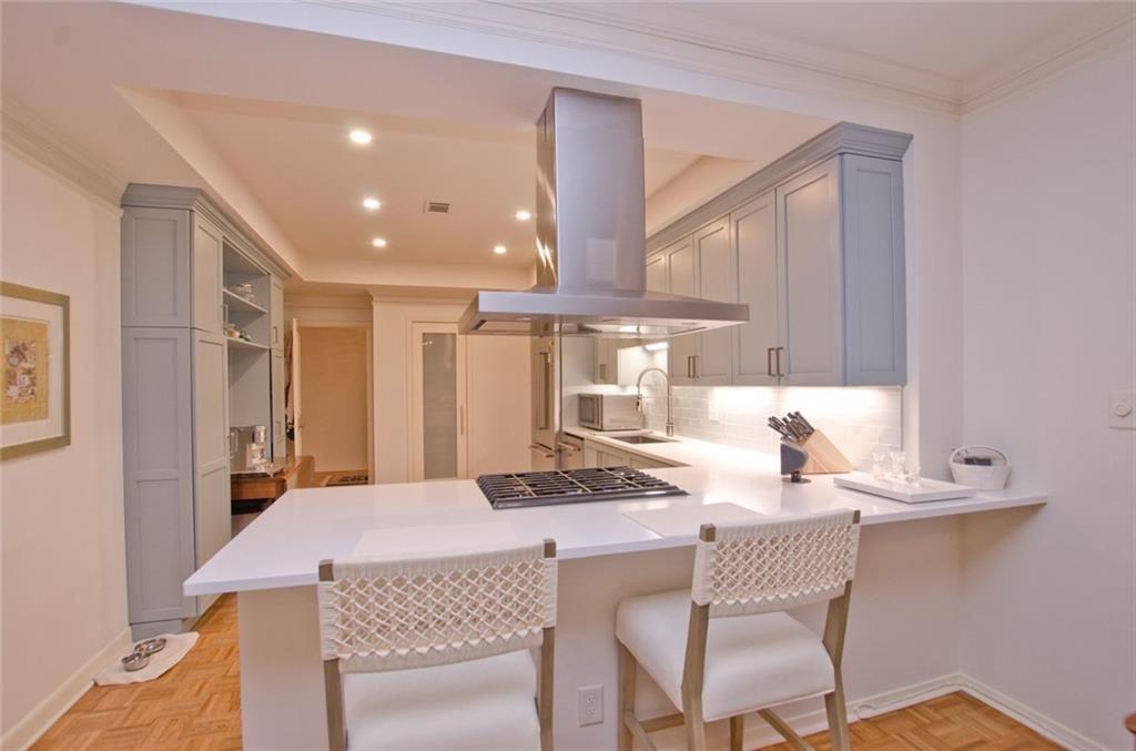 2734 Peachtree Road Northwest, Unit C101 Atlanta, GA 30305 - Photo 7 of 23 a kitchen with a table chairs and a refrigerator