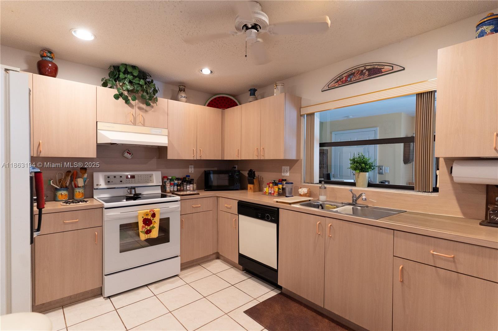 11680 Southwest 92nd Street Miami, FL 33176 - Photo 11 of 44 a kitchen with a sink window and cabinets