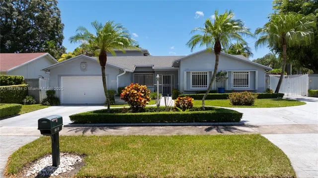 a front view of a house with swimming pool having outdoor seating