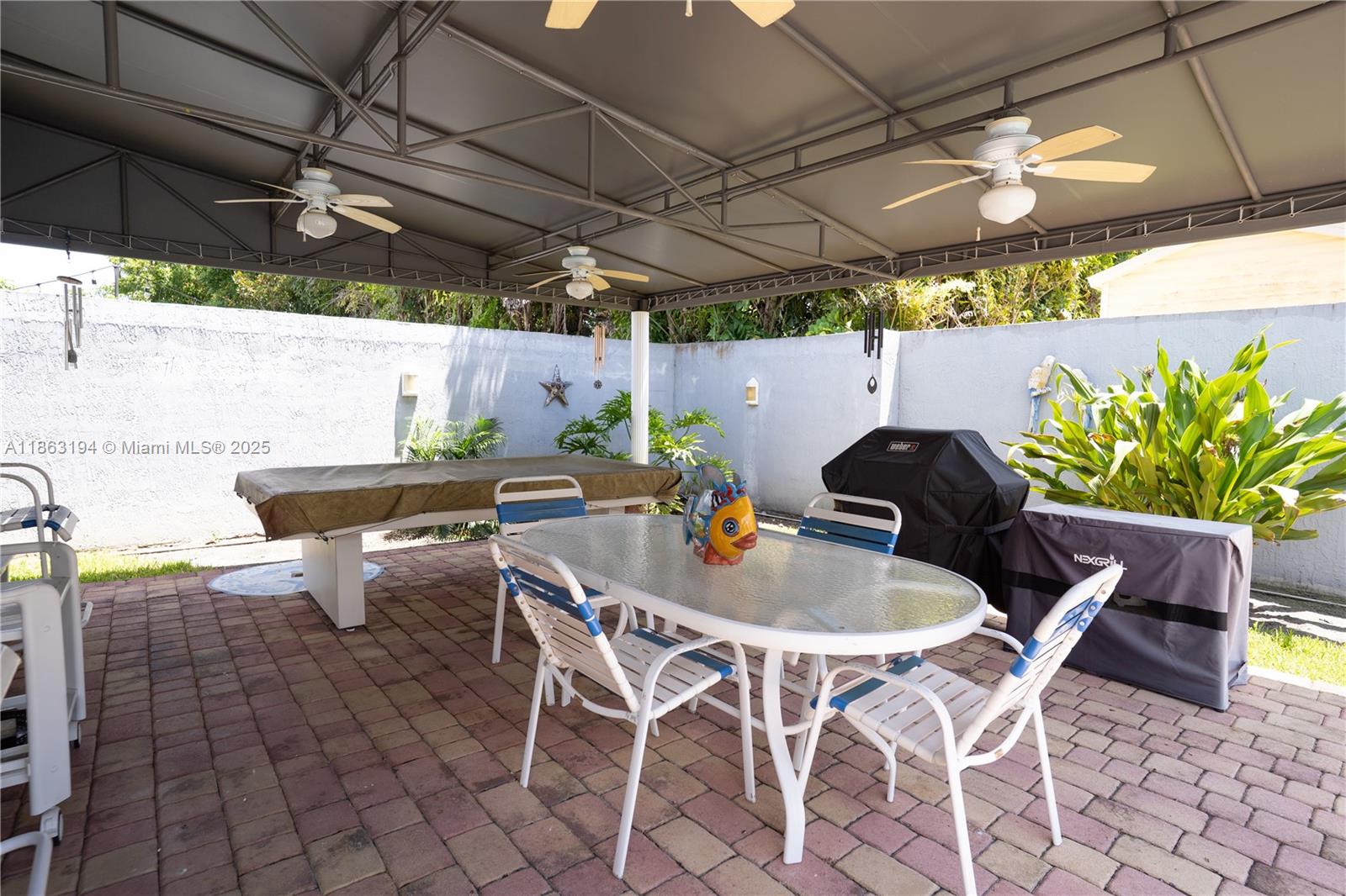 11680 Southwest 92nd Street Miami, FL 33176 - Photo 29 of 44 a outdoor dining space with furniture and outdoor kitchen