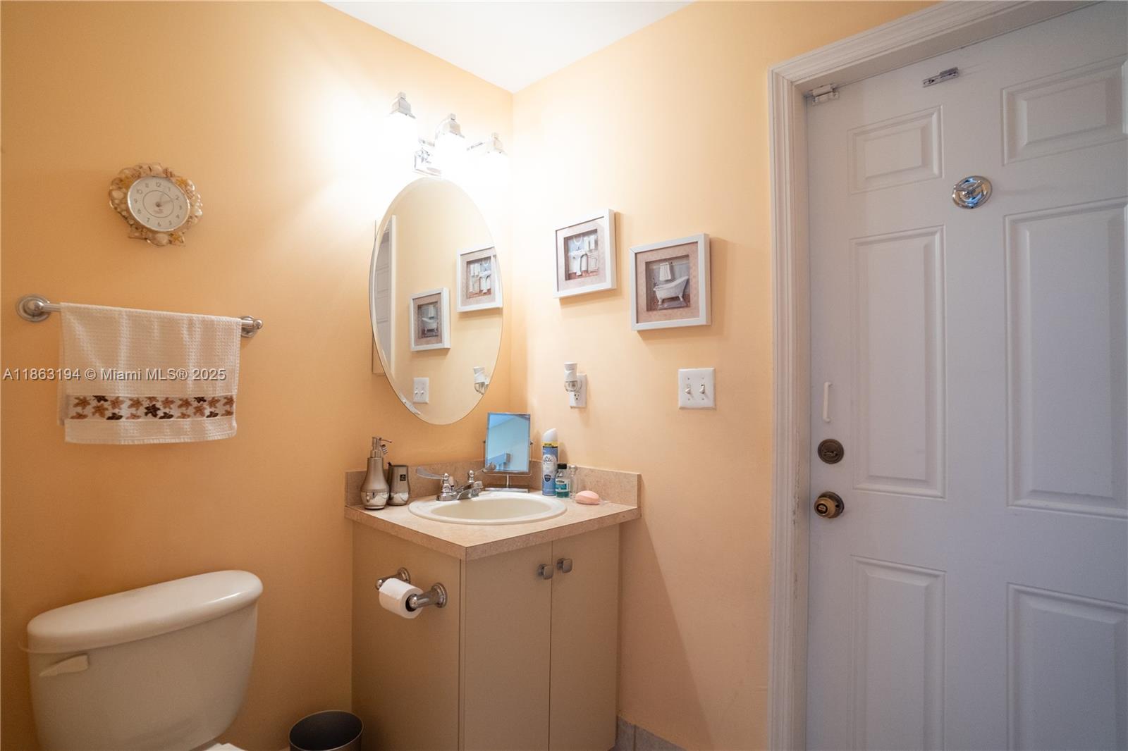 11680 Southwest 92nd Street Miami, FL 33176 - Photo 33 of 44 a bathroom with a sink mirror vanity and toilet