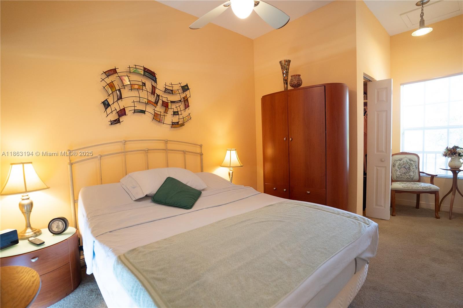 11680 Southwest 92nd Street Miami, FL 33176 - Photo 37 of 44 a bedroom with a bed and a chandelier