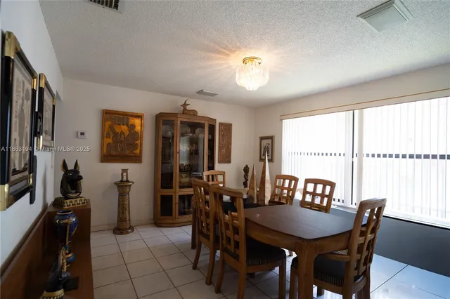 a view of a dining room with furniture and a window