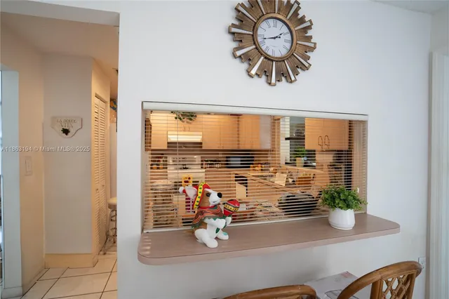 a kitchen with a sink window and cabinets