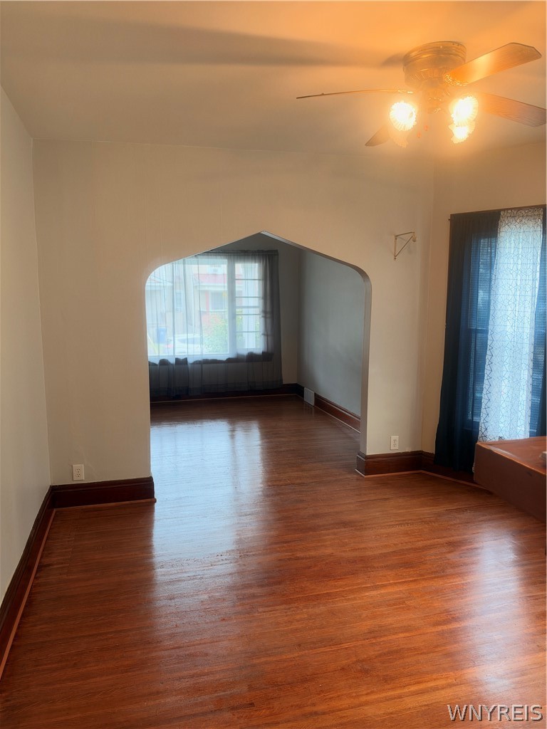 166 Herkimer Street Buffalo, NY 14213 - Photo 9 of 13 Rich hardwood flooring complements the arched door