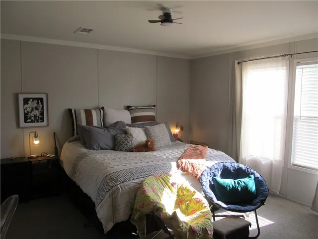 a bedroom with bed and window