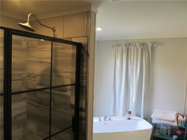 a bathroom with a bathtub sink and mirror