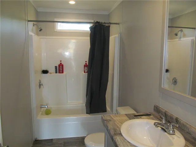 a living room with furniture a flat screen tv and a window