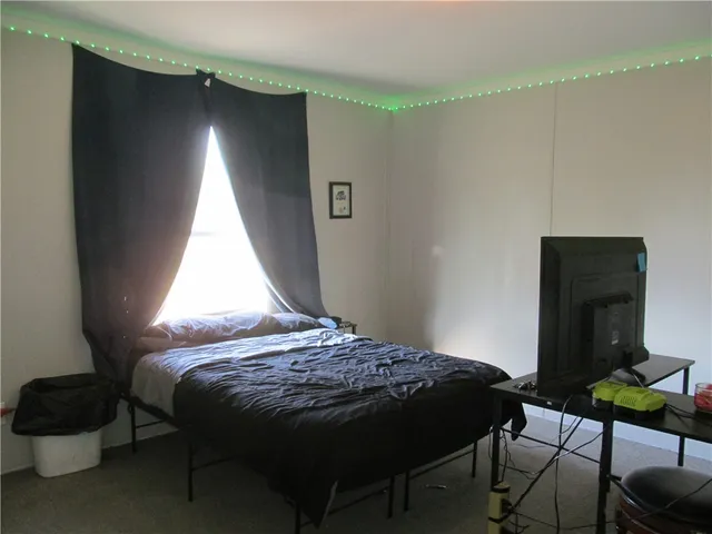 a bedroom with a bed with window