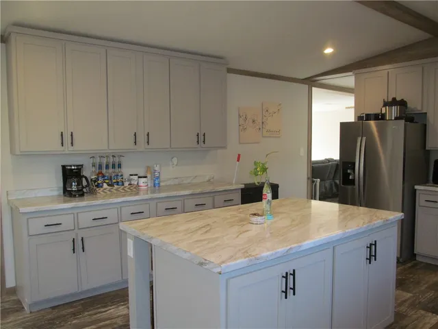 a kitchen with stainless steel appliances a refrigerator sink and cabinets