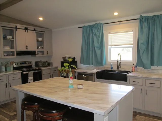 a kitchen with a stove a sink and a refrigerator