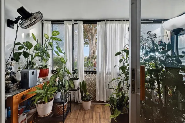 a vase of flowers sitting on a table with window