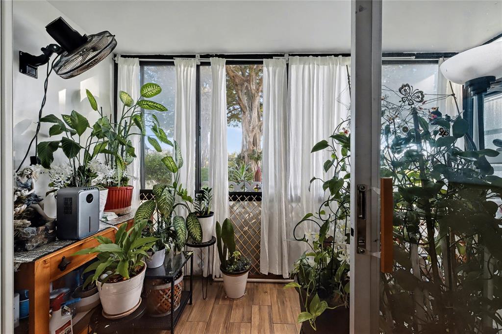 a vase of flowers sitting on a table with window