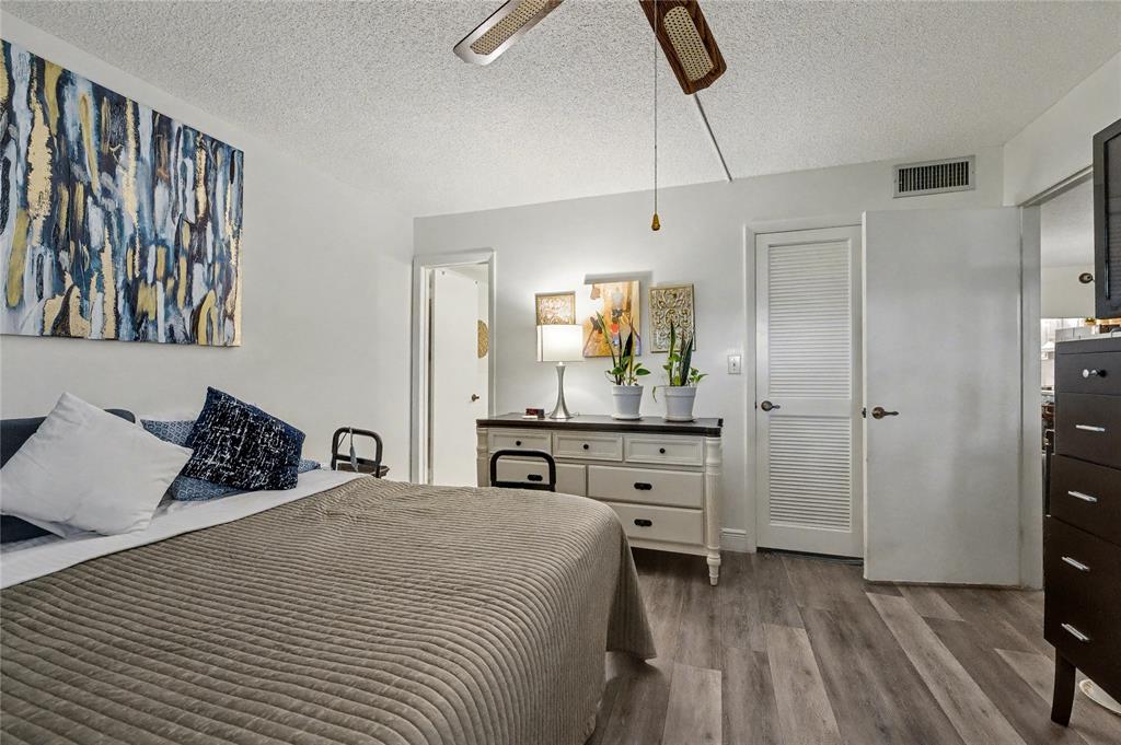 9520 South Hollybrook Lake Drive, Unit 103 Pembroke Pines, FL 33025 - Photo 12 of 55 a bedroom with a bed and a dresser