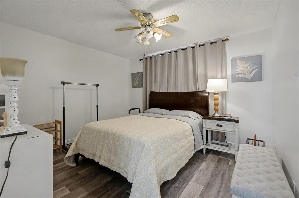 9520 South Hollybrook Lake Drive, Unit 103 Pembroke Pines, FL 33025 - Photo 14 of 55 a bedroom with a bed and a chandelier