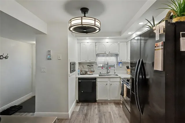 a kitchen with stainless steel appliances a refrigerator and a stove top oven