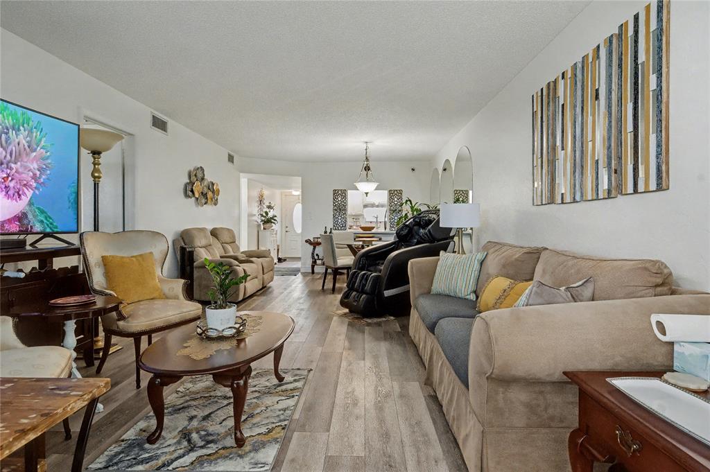 9520 South Hollybrook Lake Drive, Unit 103 Pembroke Pines, FL 33025 - Photo 3 of 55 a living room with furniture and a wooden floor