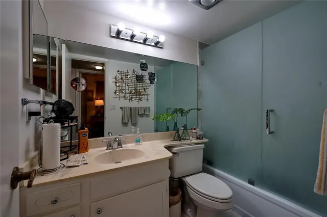 a bathroom with a toilet a sink and mirror