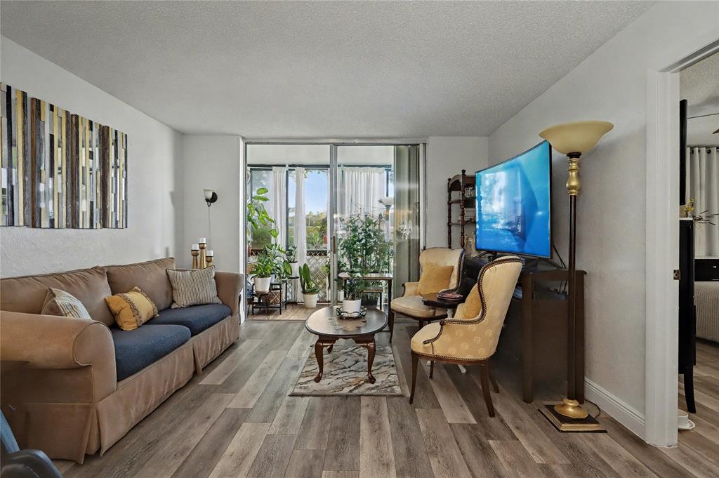9520 South Hollybrook Lake Drive, Unit 103 Pembroke Pines, FL 33025 - Photo 9 of 55 a living room with furniture and a window
