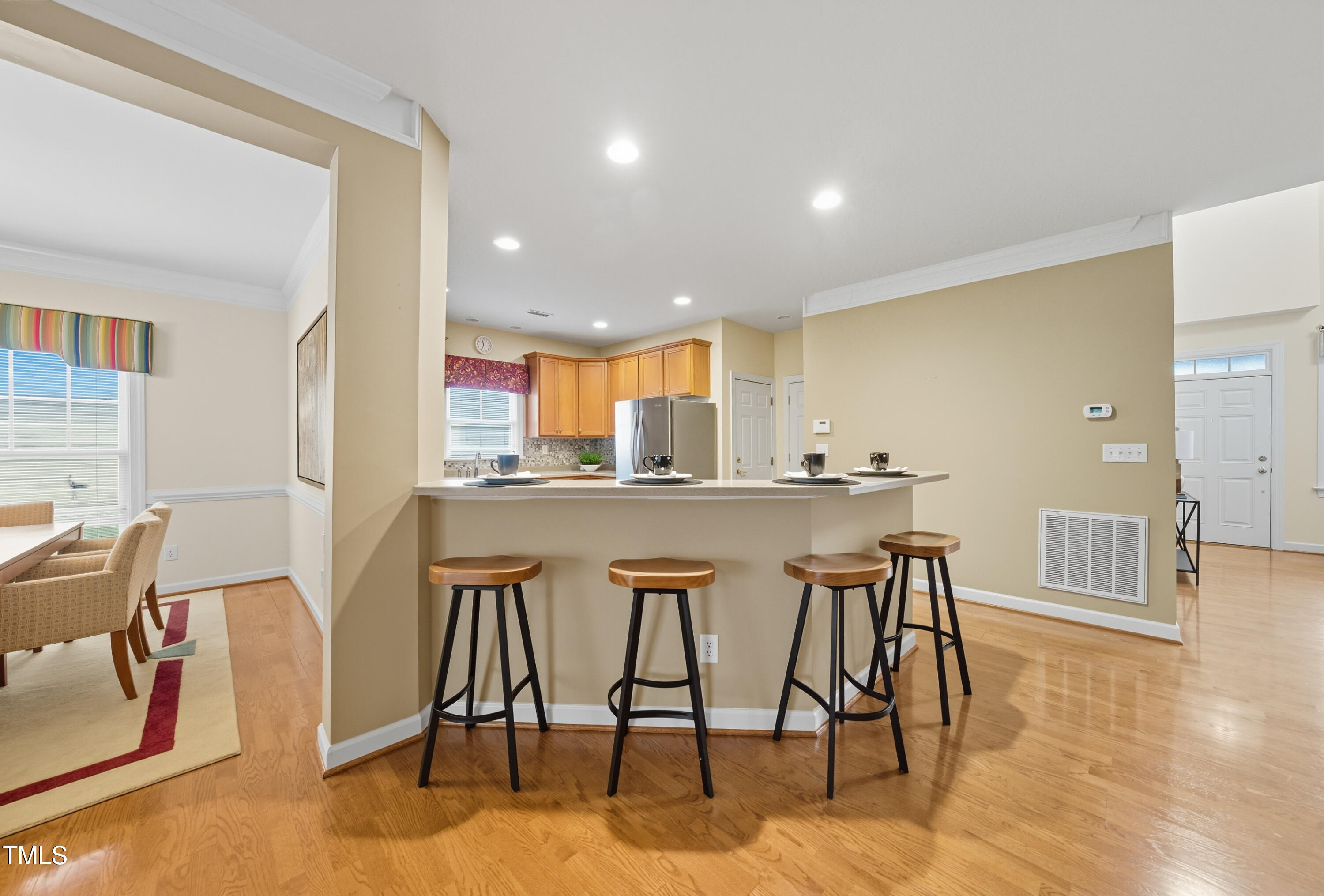 5210 Rio Grande Drive Raleigh, NC 27616 - Photo 10 of 45 a dining hall with stainless steel appliances kitchen island granite countertop a dining table chairs and view living room