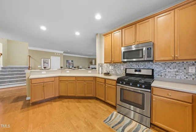 a kitchen with a stove a sink and a microwave